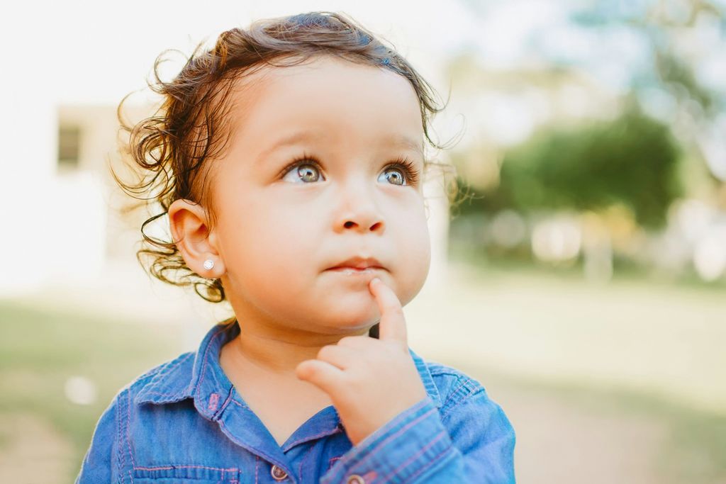 Adorable baby pondering outdoors in Martínez de la Torre, Veracruz, Mexico, sunny day.