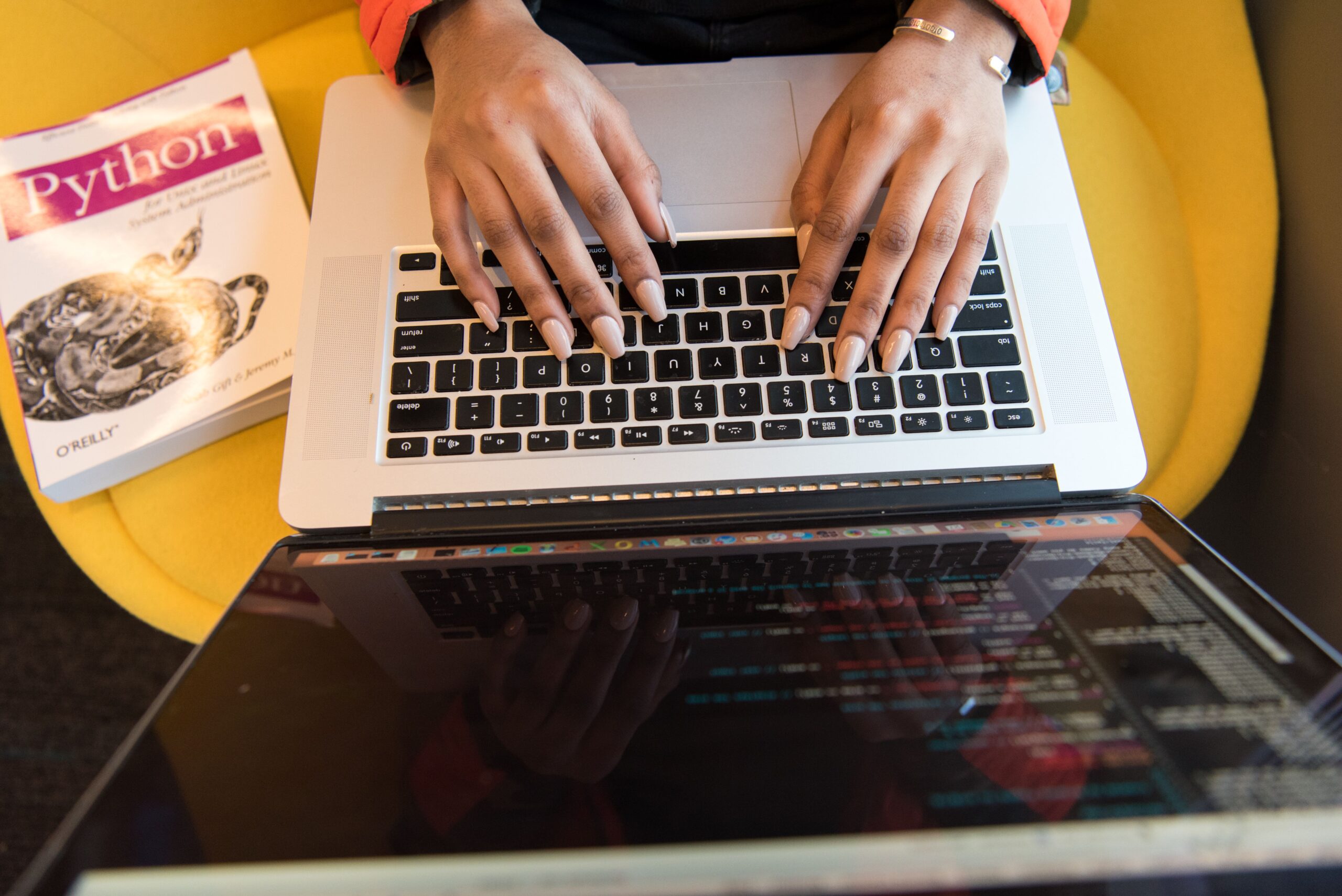 Python programming and AI student coding on a laptop